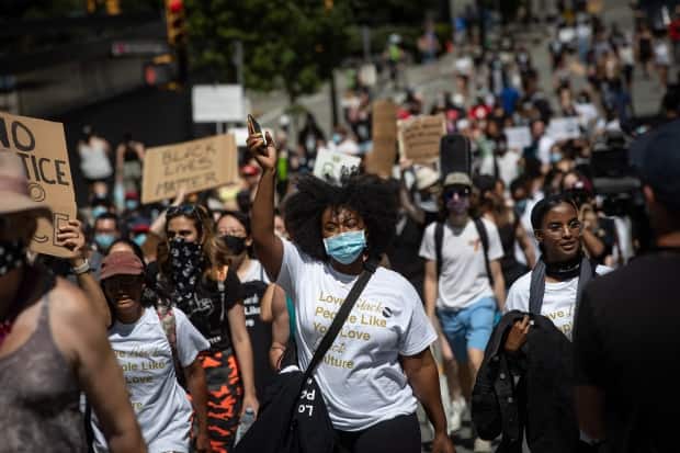 People participate in an Emancipation Day march in Vancouver on Saturday, Aug. 1, 2020, marking the abolition of slavery in parts of the British Empire. In a vote in the House of Commons earlier this year, the federal government officially recognized Emancipation Day. (Darryl Dyck/The Canadian Press - image credit)