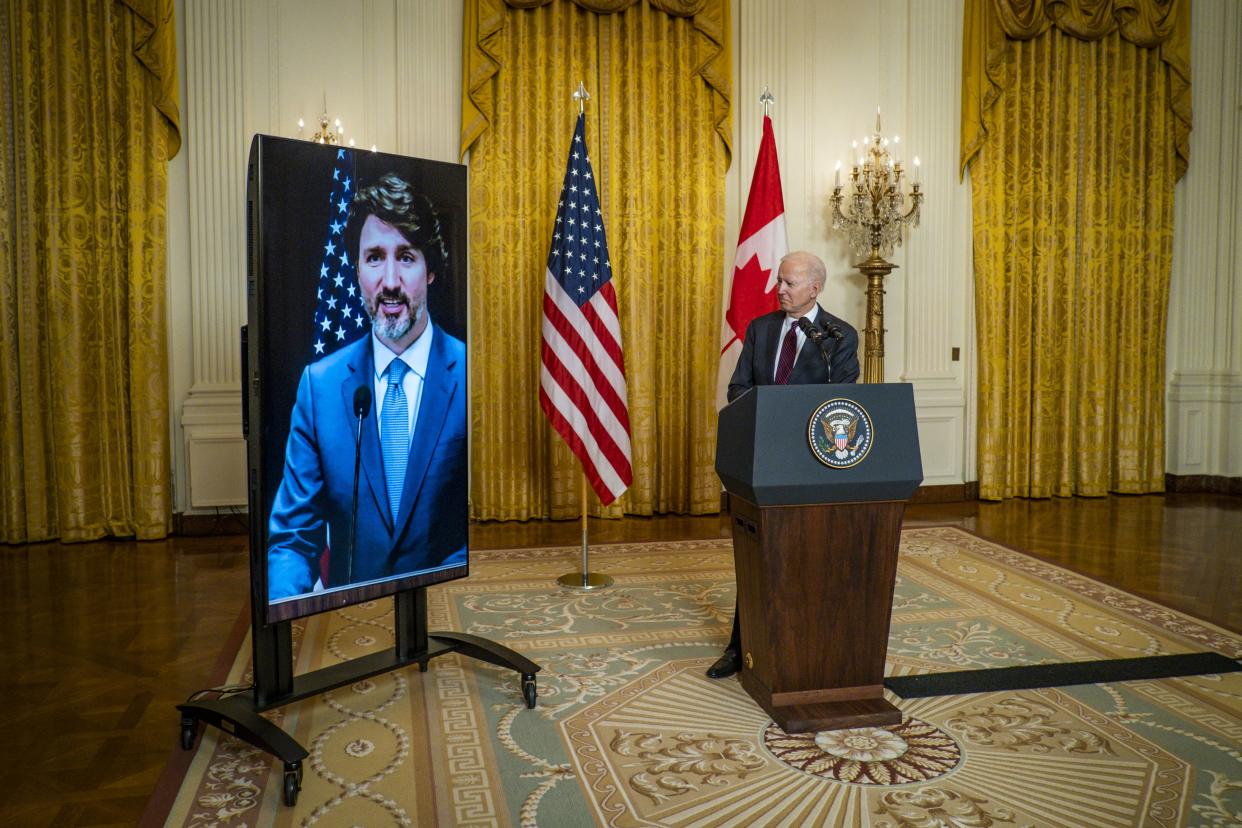 U.S. President Joe Biden and Canadian Prime Minister Justin Trudeau deliver opening statements via video link in the East Room of the White House on Feb. 23, 2021, in Washington, DC. U.S. presidents by tradition invite the Canadian prime minister for their first meeting with a world leader. The ongoing COVID-19 pandemic forced the meeting to be held virtually.