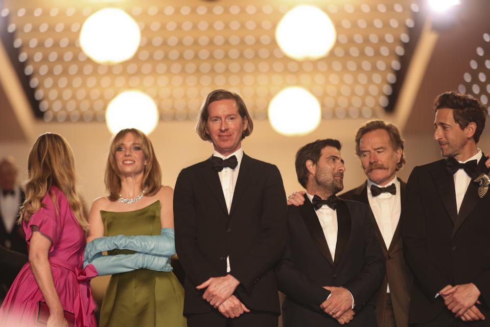 Hope Davis, from left, Maya Hawke, director Wes Anderson, Jason Schwartzman, Bryan Cranston and Adrien Brody pose for photographers upon departing the premiere of the film 'Asteroid City' at the 76th international film festival, Cannes, southern France, Tuesday, May 23, 2023. (Photo by Vianney Le Caer/Invision/AP)