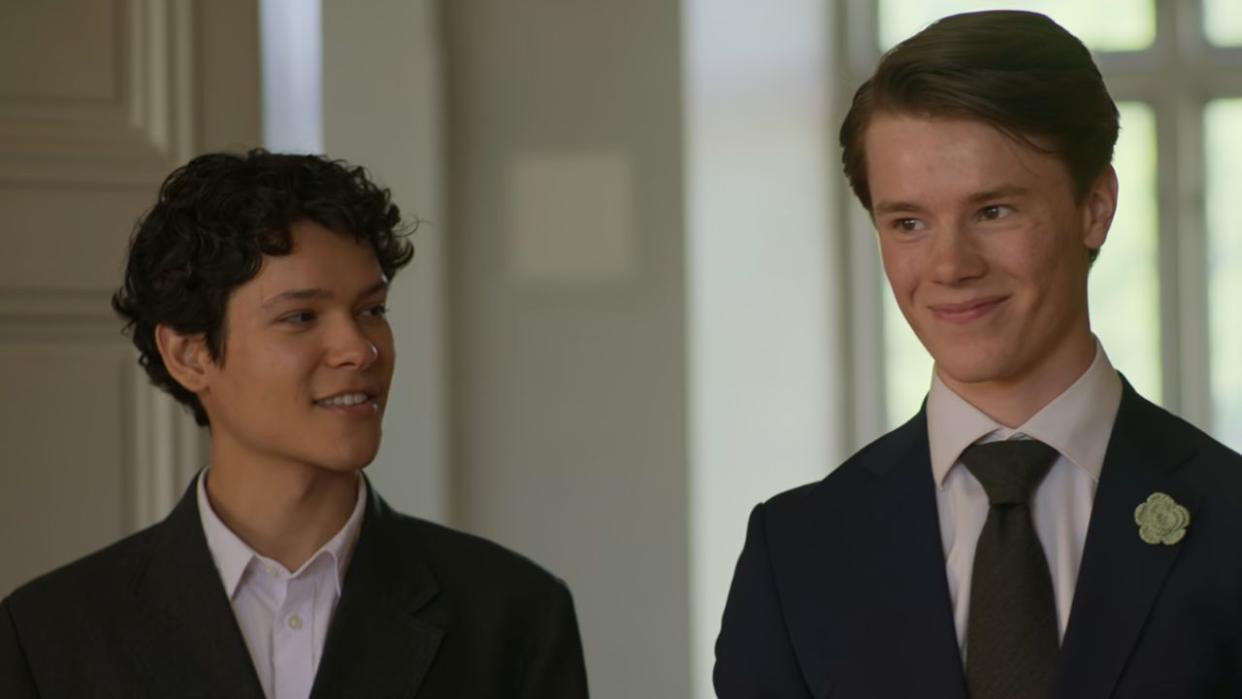  Simon smiling at Wilhelm in the Palace in Young Royals Season 3. 