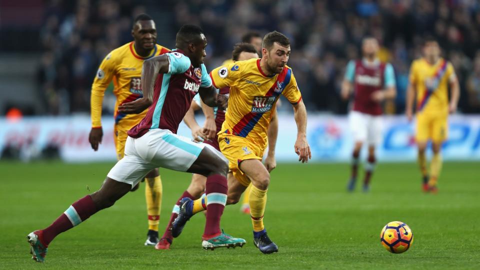 <p>Michail Antonio of West Ham United (L) takes the ball past Damien Delaney of Crystal Palace</p>