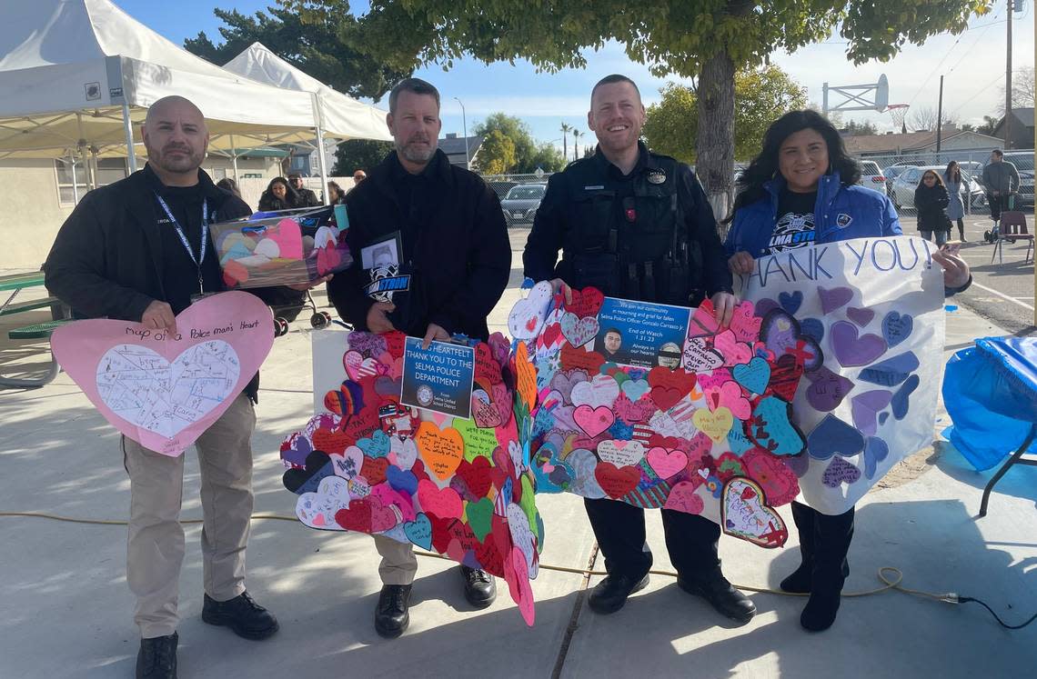 Eric White Elementary Principal Michelle Salcido presents Selma Police Department officers with cards and posters of support made by Selma Unified students after a Tuesday, February, 14, 2023 event, recognizing them for their service to the school community.