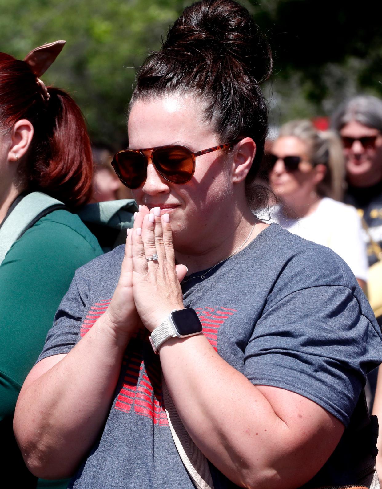 Amanda Murdock prays with others during a prayer vigil held on Thursday, May 9, 2024, for Asher Sullivan, the son of Superintendent/Director of Schools at Rutherford County Schools James “Jimmy” Sullivan, who was involved in a tragic accident last night after the storm, on Wednesday. The vigil was held in the parking lot of the Rutherford County School Central Office.