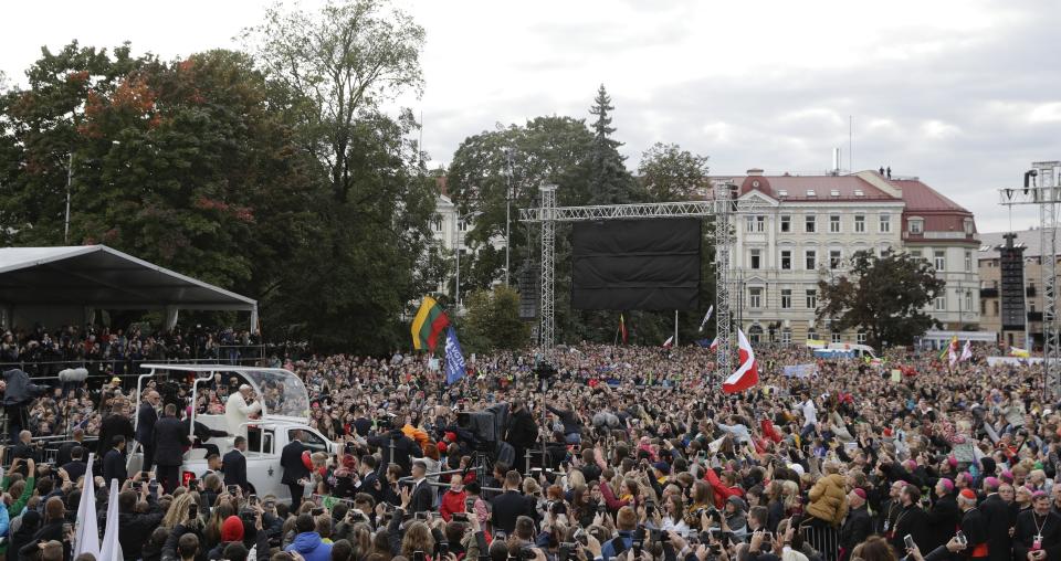 Pope Francis greets faithful as he arrives for a meeting with youths in Vilnius, Lithuania, Saturday, Sept. 22, 2018. Pope Francis begins a four-day visit to the Baltics amid renewed alarm about Moscow's intentions in the region it has twice occupied. (AP Photo/Andrew Medichini)