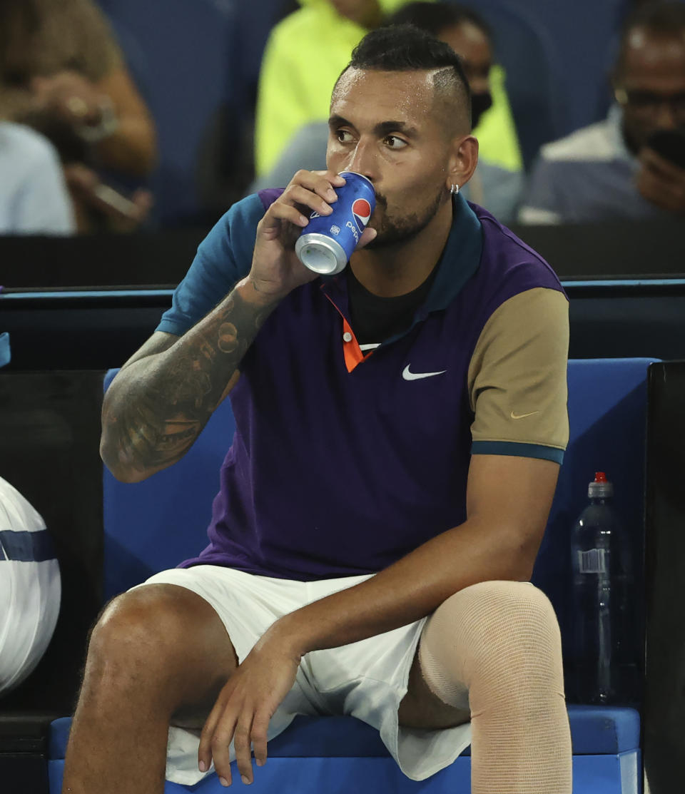 Australia's Nick Kyrgios takes a drink during his third round match against Austria's Dominic Thiem at the Australian Open tennis championship in Melbourne, Australia, Friday, Feb. 12, 2021.(AP Photo/Hamish Blair)