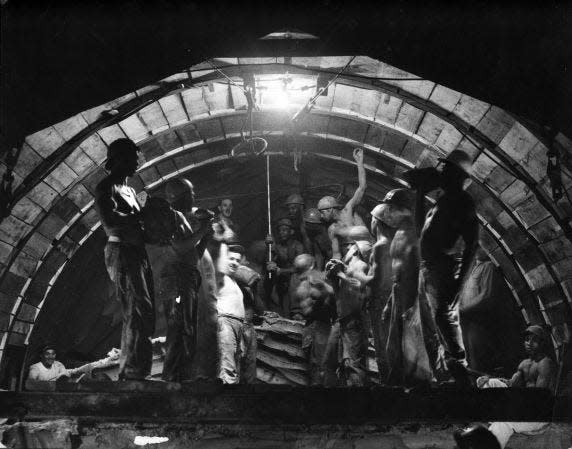 "The Muckers" (1956) by late Detroit Free Press Photographer Tony Spina. Workers excavate a utility tunnel underneath Detroit, Michigan. Part of a series.