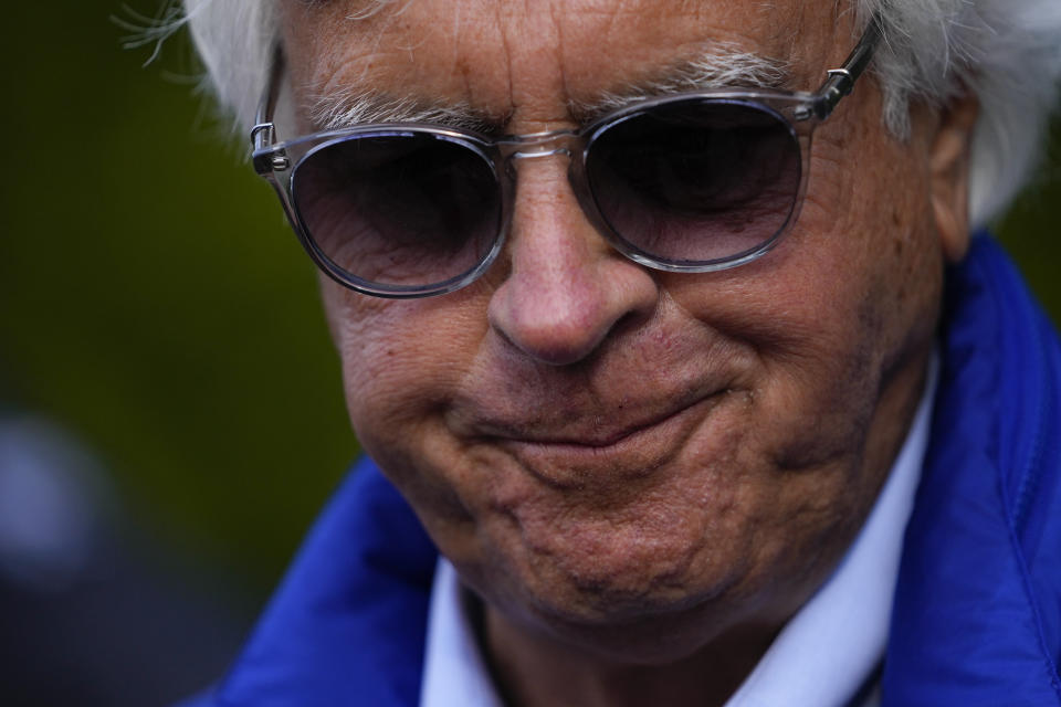 Bob Baffert, center, owner of Preakness Stakes entrant National Treasure, walks near the stables ahead of the 148th running of the Preakness Stakes horse race at Pimlico Race Course, Friday, May 19, 2023, in Baltimore. (AP Photo/Julio Cortez)