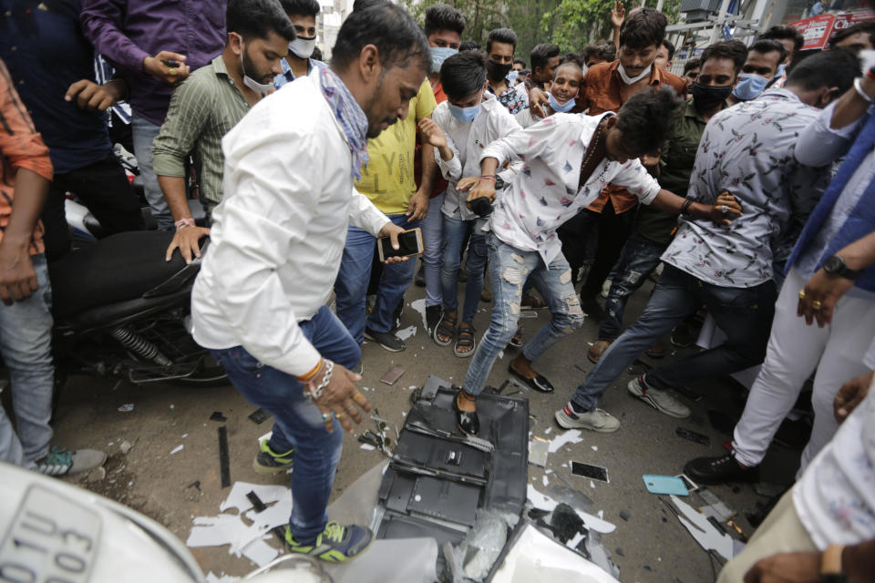 Karni Sena supporters stamp on Chinese made products during a protest against China in Ahmedabad, India, Wednesday, June 24, 2020. Chinese and Indian military commanders have agreed to disengage their forces in a disputed area of the Himalayas following a clash that left at least 20 soldiers dead, both countries said Tuesday. The commanders reached the agreement Monday in their first meeting since the June 15 confrontation, the countries said. (AP Photo/Ajit Solanki)