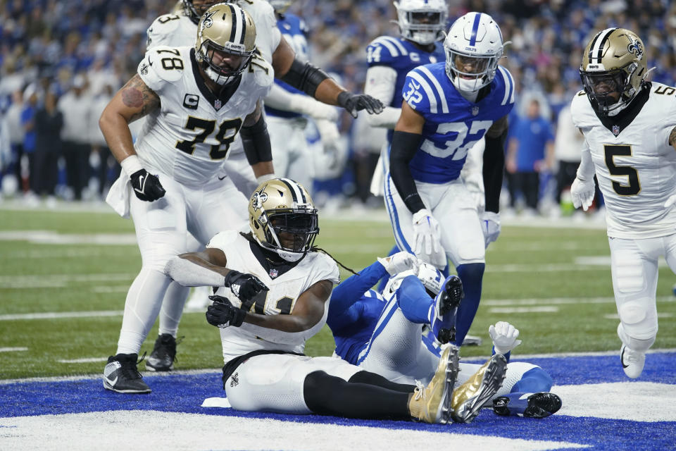 New Orleans Saints running back Alvin Kamara (41) celebrates his 16-yard touchdown run against the Indianapolis Colts during the second half of an NFL football game Sunday, Oct. 29, 2023 in Indianapolis. (AP Photo/Michael Conroy)