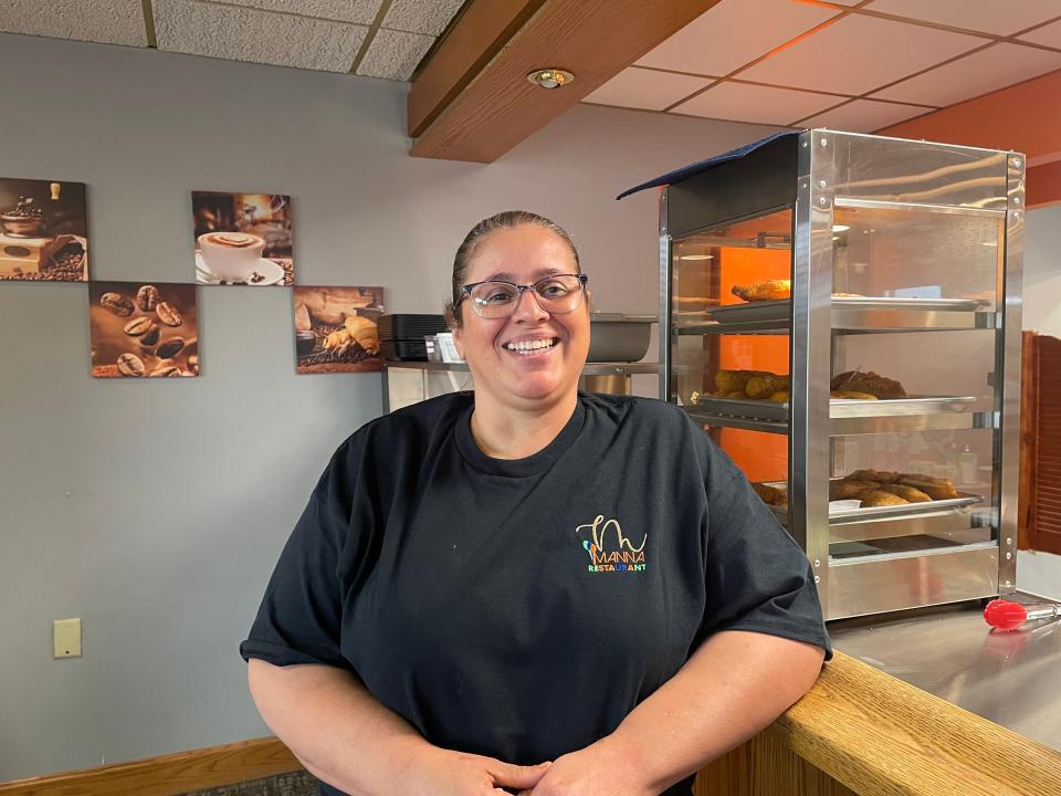Maria Galan, owner of Manna restaurant, stands next to a steamer filled with deep-fried items available for customers. Manna, featuring authentic Puerto Rican food, opened Tuesday.