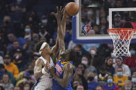 Orlando Magic center Wendell Carter Jr., left, is fouled by Golden State Warriors forward Draymond Green during the first half of an NBA basketball game in San Francisco, Monday, Dec. 6, 2021. (AP Photo/Jeff Chiu)