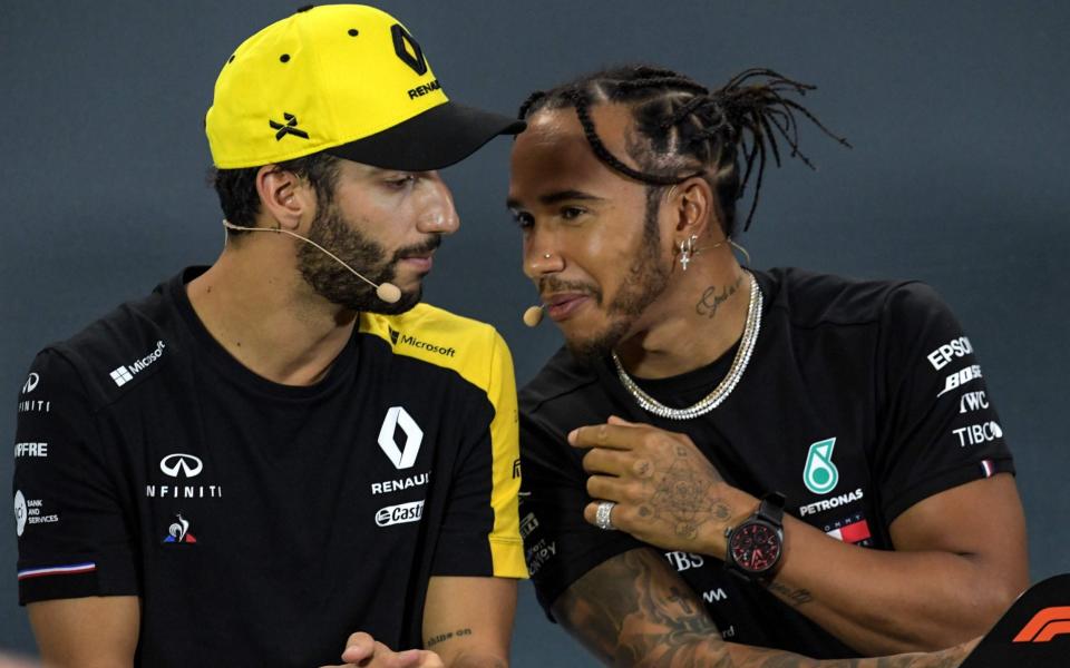 Lewis Hamilton and Daniel Ricciardo share a joke at the post-Friday practice press conference in SIngapore - AFP