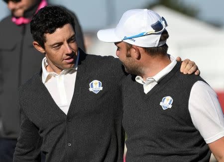 Sep 29, 2016; Chaska, MN, USA; Rory McIlroy of Northern Ireland and Andy Sullivan of England walk off the first tee during a practice round for the 41st Ryder Cup at Hazeltine National Golf Club. Mandatory Credit: Michael Madrid-USA TODAY Sports