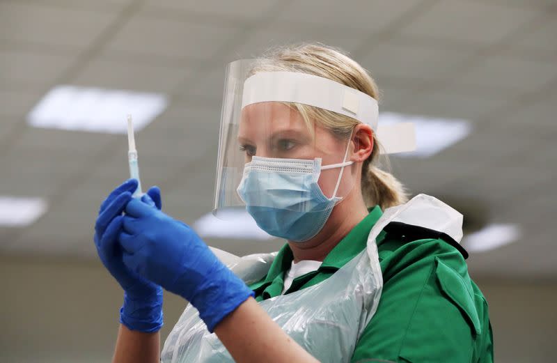 FILE PHOTO: A St John's Ambulance volunteer holds a syringe during a coronavirus disease (COVID-19) vaccinator training course at the Princess Anne Training Centre in Derby