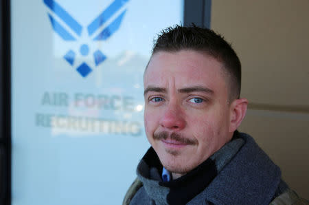 Nicholas Bade, 37, who is among the transgender Americans who this month can enlist openly in the U.S. military for the first time after courts blocked President Donald TrumpÕs effort to re-establish a ban on transgender service members, poses outside a recruitment center in Chicago, Illinois, U.S., January, 4, 2018. Photo taken January 4, 2018. REUTERS/Chris Kenning