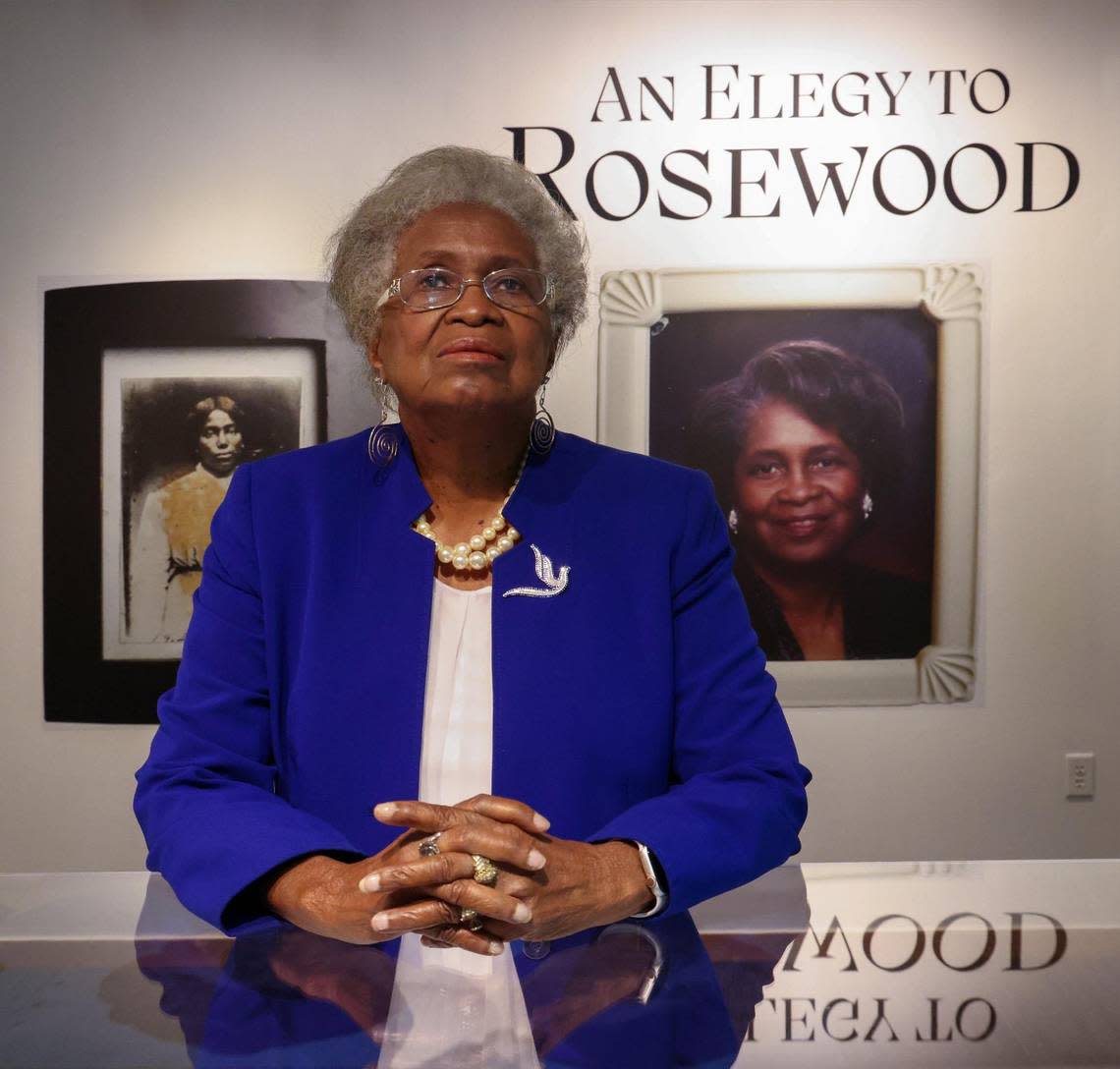 Lizzie Robinson Jenkins is photographed in front of portraits of her grandmother and herself, part of the exhibition “An Elegy to Rosewood,” in commemoration of the 100 year anniversary of the Rosewood Massacre at FIU’s Frost Art Museum.