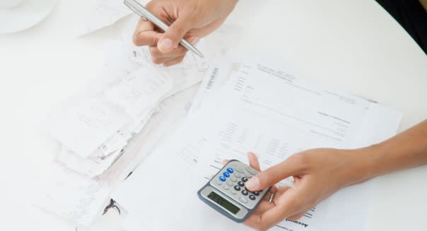 Woman at table paying bills