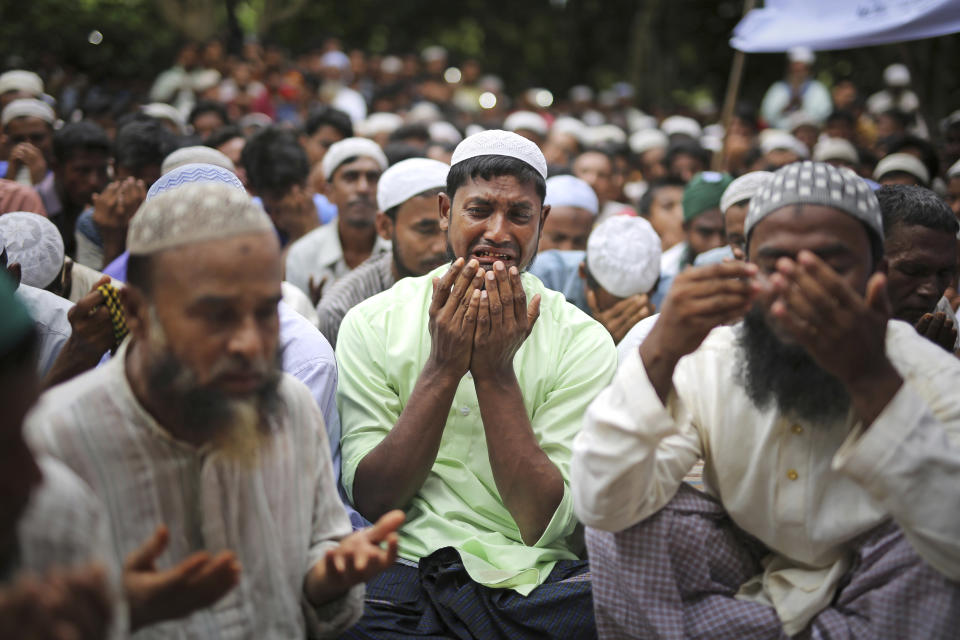 In this Aug. 25, 2018, file photo, Rohingya refugees cry as they pray during a gathering to commemorate the first anniversary of Myanmar army's crackdown which lead to a mass exodus of Rohingya Muslims to Bangladesh, at Kutupalong refugee camp in Bangladesh. Thousands of Rohingya Muslim refugees on Saturday marked the one-year anniversary of the attacks that sent them fleeing to safety in Bangladesh, praying they can return to their homes in Myanmar and demanding justice for their dead relatives and neighbors. (AP Photo/Altaf Qadri, File)