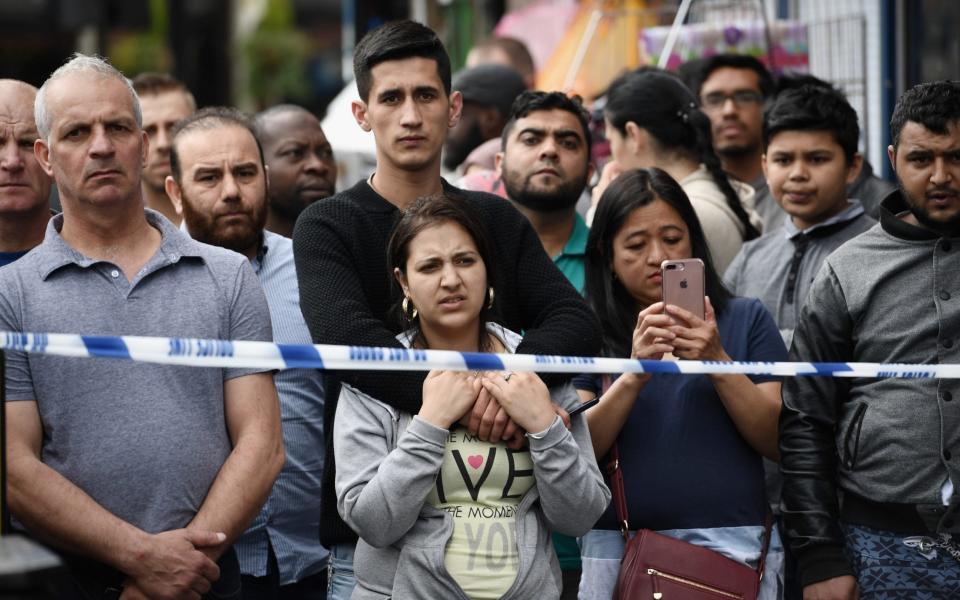 Members of the public view the scene after police officers raided a property in East Ham - Credit: Carl Court/Getty Images