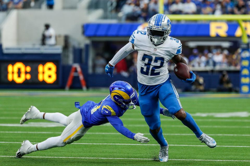 Detroit Lions running back D'Andre Swift (32) runs against Los Angeles Rams cornerback Donte' Deayon (21) during the second half at the SoFi Stadium in Inglewood, Calif. on Sunday, Oct. 24, 2021.