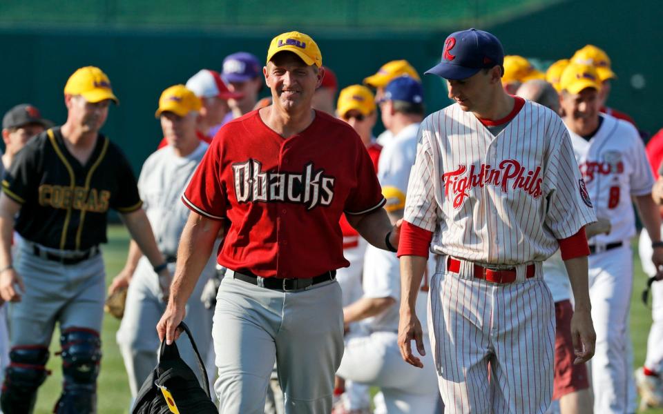 Sen. Jeff Flake, R-Ariz., left, walks with Rep. Ryan Costello, R-Pa., before the Congressional baseball game - Credit: Alex Brandon/AP