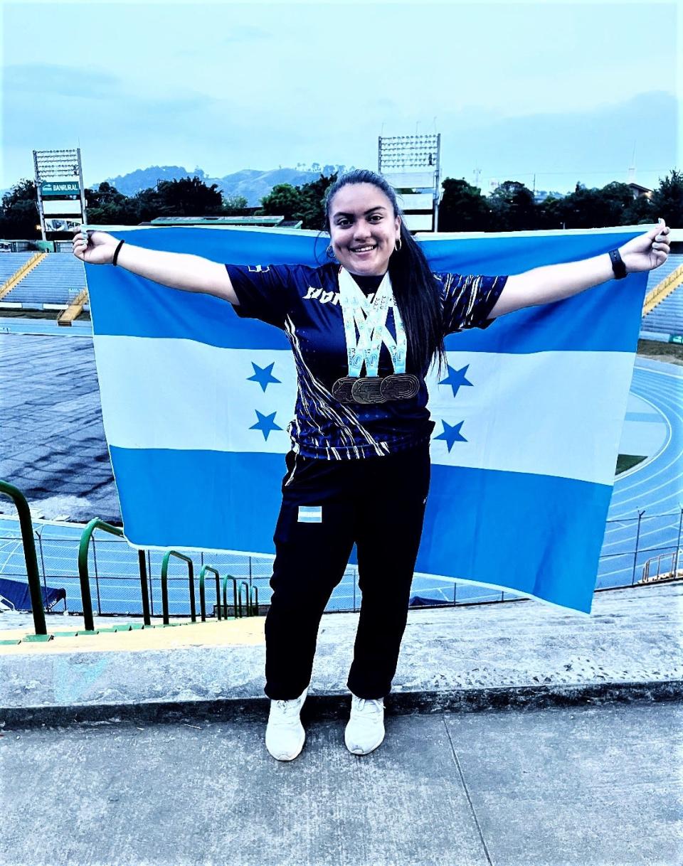 Ursuline's Prizila Negrete stands with the Honduran flag after winning the U20 shot put at the U18 and U20 Central American Games in Guatemala June 3. Negrete set a women's U20 Central American record in the event.
