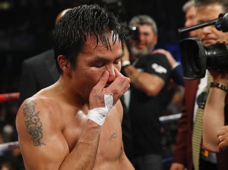 Manny Pacquiao of the Philippines reacts after losing to Floyd Mayweather, Jr. of the U.S. following their welterweight WBO, WBC and WBA (Super) title fight in Las Vegas, Nevada, May 2, 2015. REUTERS/Steve Marcus