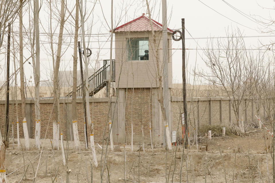 FILE - A security guard watches from a tower around a detention facility in Yarkent County in northwestern China's Xinjiang Uyghur Autonomous Region on March 21, 2021. As world leaders gather in New York at the annual U.N. General Assembly, rising superpower China is also focusing on another United Nations body that is meeting across the Atlantic Ocean in Geneva. (AP Photo/Ng Han Guan, File)