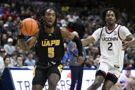 Arkansas-Pine Bluff guard Rashad Williams (5) drives to the basket as UConn guard Tristen Newton (2) defends in the first half of an NCAA college basketball game, Saturday, Dec. 9, 2023, in Storrs, Conn. (AP Photo/Jessica Hill)