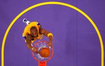 FILE PHOTO: Late Lakers star Kobe Bryant slam dunks against the Sacramento Kings during 2011 NBA basketball game in Los Angeles