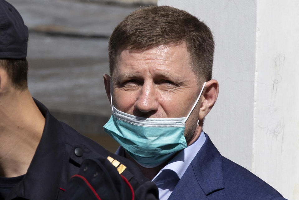 A governor of the Khabarovsk region along the border with China, Sergei Furgal is escorted from a court room in Moscow, Russia, Friday, July 10, 2020. A provincial governor in Russia's far east has been arrested on charges of involvement in multiple murders and was flown to Moscow. The court ordered Frugal to be jailed for two months as the investigation continues. (AP Photo/Alexander Zemlianichenko)