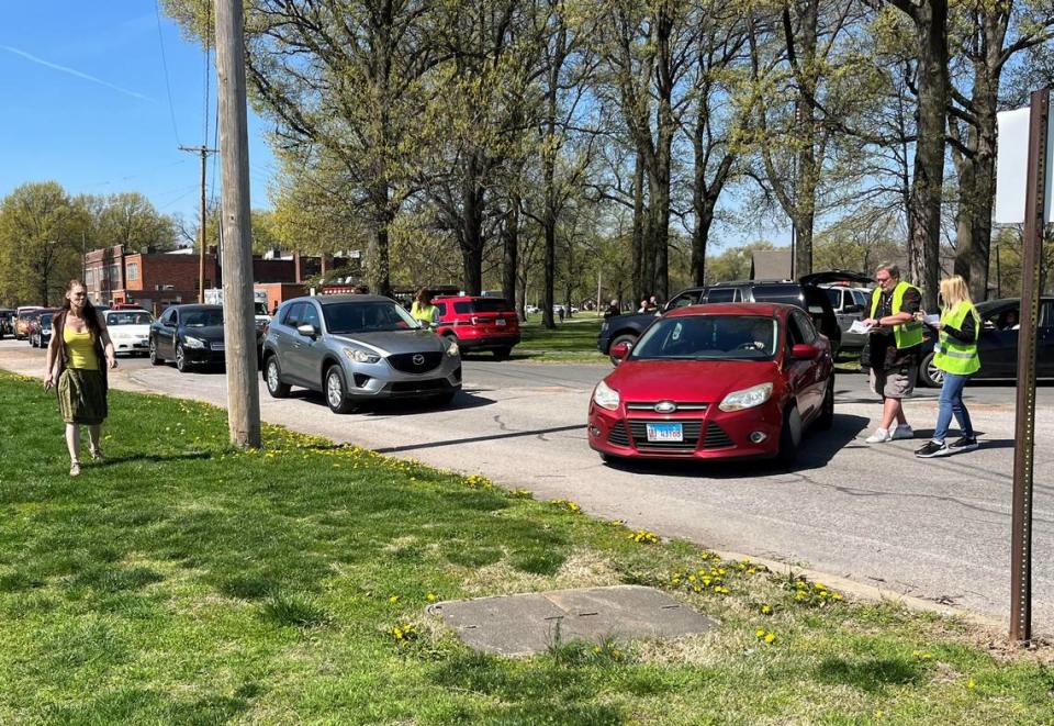 Granite City School District 9 staff in florescent vests meet with parents during early dismissal Wednesday to track the departure of students.