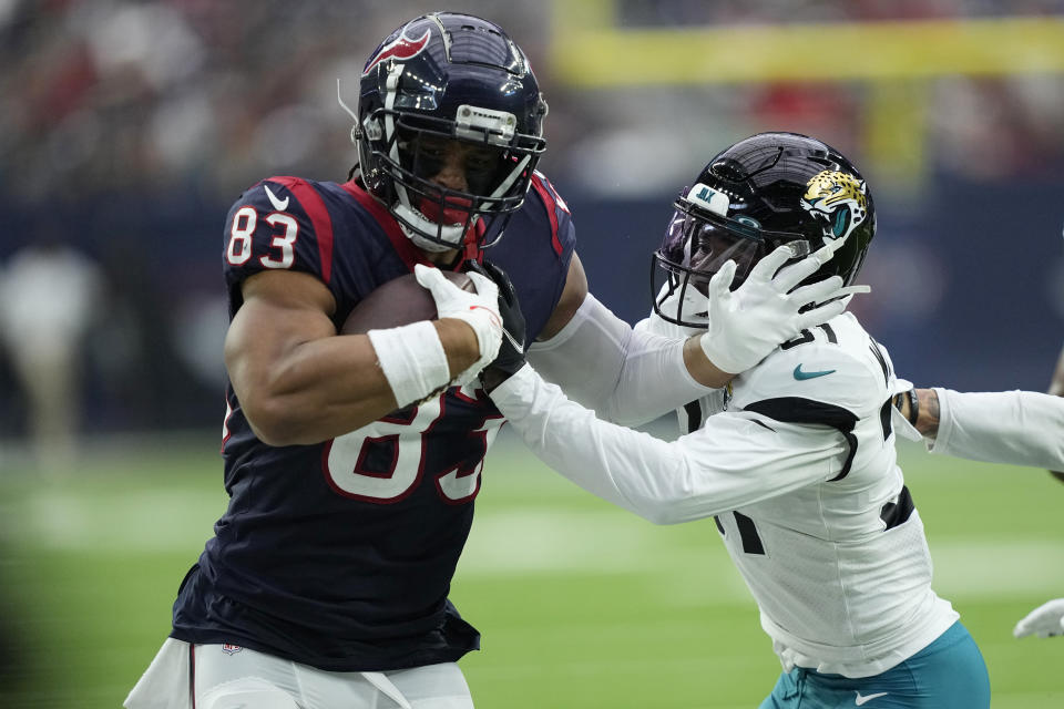 Houston Texans tight end O.J. Howard (83) is hit by Jacksonville Jaguars cornerback Darious Williams (31) after making a catch for a first down during the first half of an NFL football game in Houston, Sunday, Jan. 1, 2023. (AP Photo/David J. Phillip)