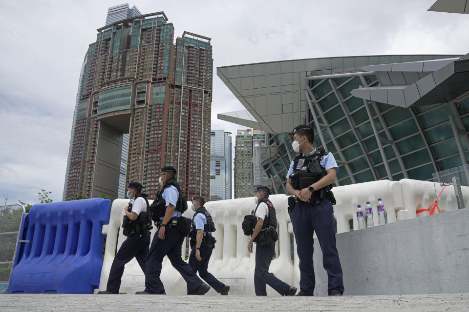 Police officers patrol outside the high speed train station for the Chinese president Xi Jinping's visit to mark the 25th anniversary of Hong Kong handover to China, in Hong Kong, Thursday, June 30, 2022. (AP Photo/Kin Cheung)