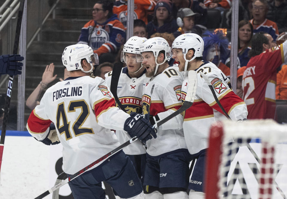 Florida Panthers' Gustav Forsling (42), Anton Lundell (15), Vladimir Tarasenko (10) and Eetu Luostarinen (27) celebrate a goal against the Edmonton Oilers during the first period of Game 4 of the NHL hockey Stanley Cup Final, Saturday, June 15, 2024, in Edmonton, Alberta. (Jason Franson/The Canadian Press via AP)