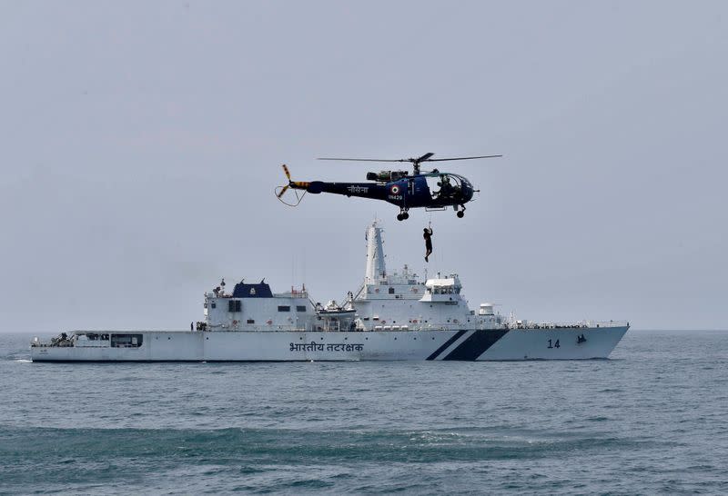 FILE PHOTO: An Indian Navy "Chetak" helicopter demonstrates a rescue operation past the Coast Guard's Offshore Patrol Vessel (OPV) "Sarathi" during a media tour in the Arabian Sea near Kochi