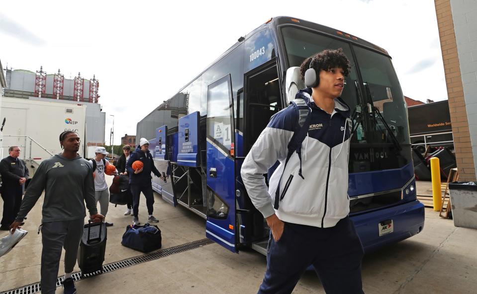 Akron's Enrique Freeman, right, enters PPG Paints Arena before an open practice Wednesday before the Zips' first-round NCAA Tournament game against Creighton on Thursday in Pittsburgh.