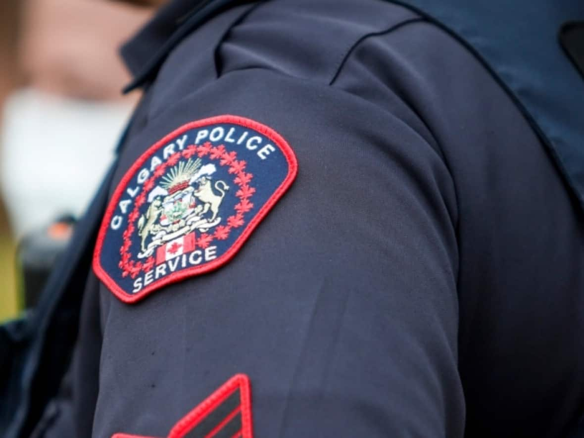 A Calgary police spokesperson said there was a 41 per cent drop in ransomware attacks reported to CPS year-over-year. Nationally, the number of reported attacks has fallen as well.  (Jeff McIntosh/The Canadian Press, Marcio Jose Sanchez/Associated Press - image credit)