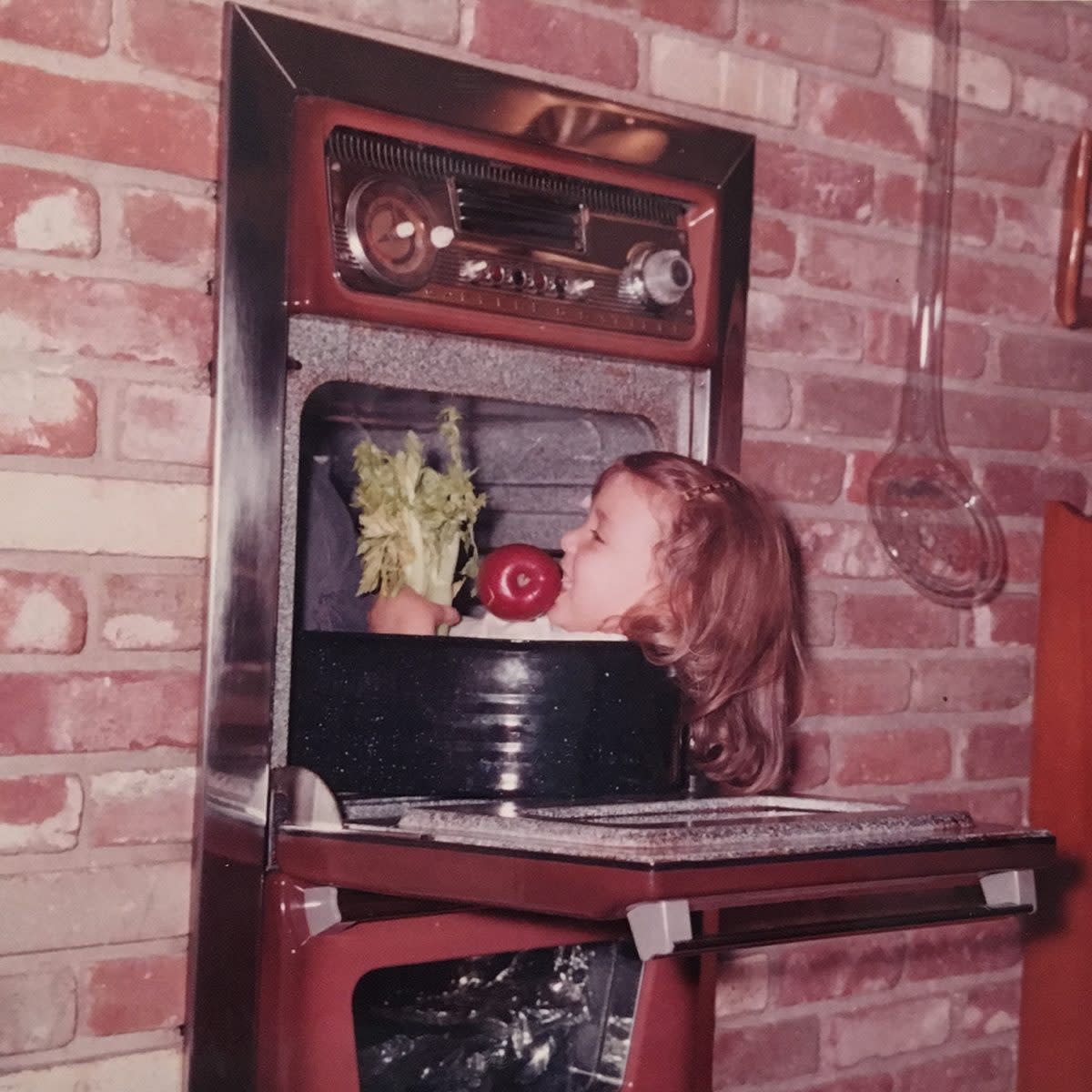 little girl pretending to be cooked in oven on thanksgiving