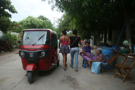 Ximena, 26 and Peregrina, 26, indigenous Zapotec transgender women also knows as Muxe, walks on a street after an earthquake that struck on the southern coast of Mexico late on Thursday, in Juchitan, Mexico, September 10, 2017. REUTERS/Edgard Garrido