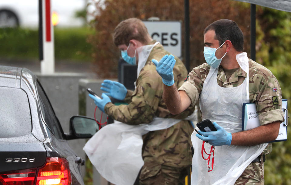 Soldiers provide instructions to people arriving at a Covid-19 testing centre in a Park and Ride facility in Salisbury, Wiltshire, as the UK continues in lockdown to help curb the spread of the coronavirus. (Photo by Andrew Matthews/PA Images via Getty Images)