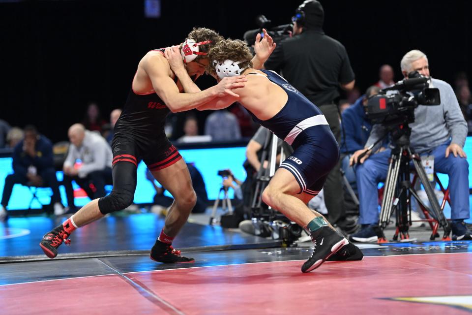 Wisconsin's Dean Hamiti (left) locks up with Penn State's Mitchell Mesenbrink during the 165-pound final of the Big Ten wrestliing championships at XFINITY Center in College Park, Maryland on Sunday March 10, 2024.