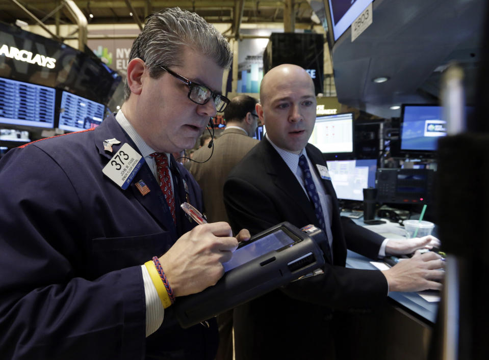 Trader John Panin, left, and specialist Jay Woods work on the floor of the New York Stock Exchange Tuesday, Jan. 28, 2014. Stocks are higher in early trading on Wall Street as the stock market turns positive after three days of losses. (AP Photo/Richard Drew)