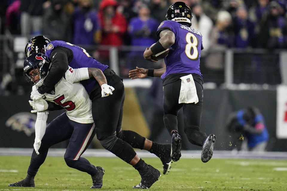 Baltimore Ravens quarterback Lamar Jackson (8) runs down field against the Houston Texans during the second half of an NFL football AFC divisional playoff game, Saturday, Jan. 20, 2024, in Baltimore. (AP Photo/Julio Cortez)