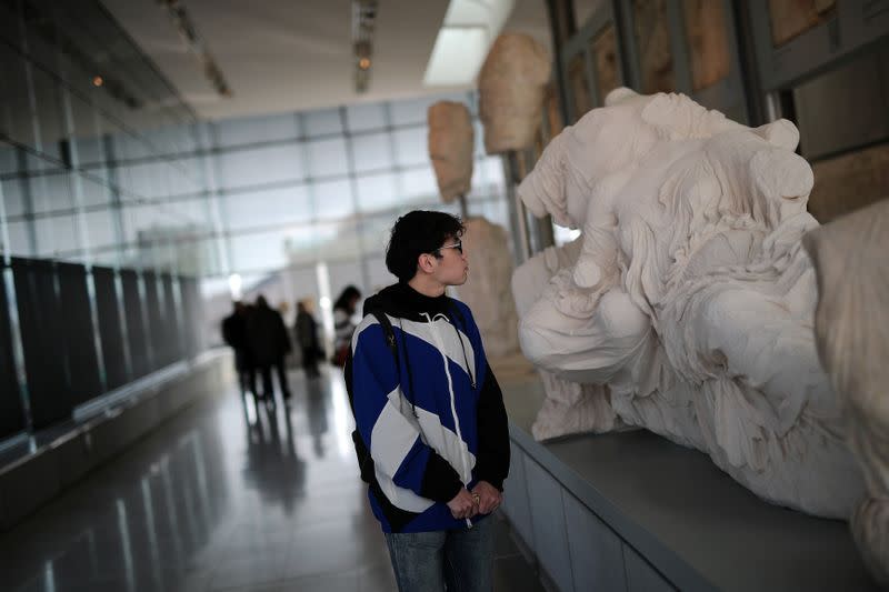 A man visits the Parthenon Gallery of the Acropolis Museum, where original sculptures and plaster cast copies of the frieze of the Parthenon temple are exhibited, in Athens