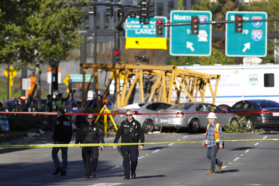 Emergency crews work at the scene of a construction crane collapse where several people were killed and others were injured Saturday, April 27, 2019, in the South Lake Union neighborhood of Seattle. The crane collapsed near the intersection of Mercer Street and Fairview Avenue pinning cars underneath it near Interstate 5 shortly after 3 p.m. (AP Photo/Joe Nicholson)