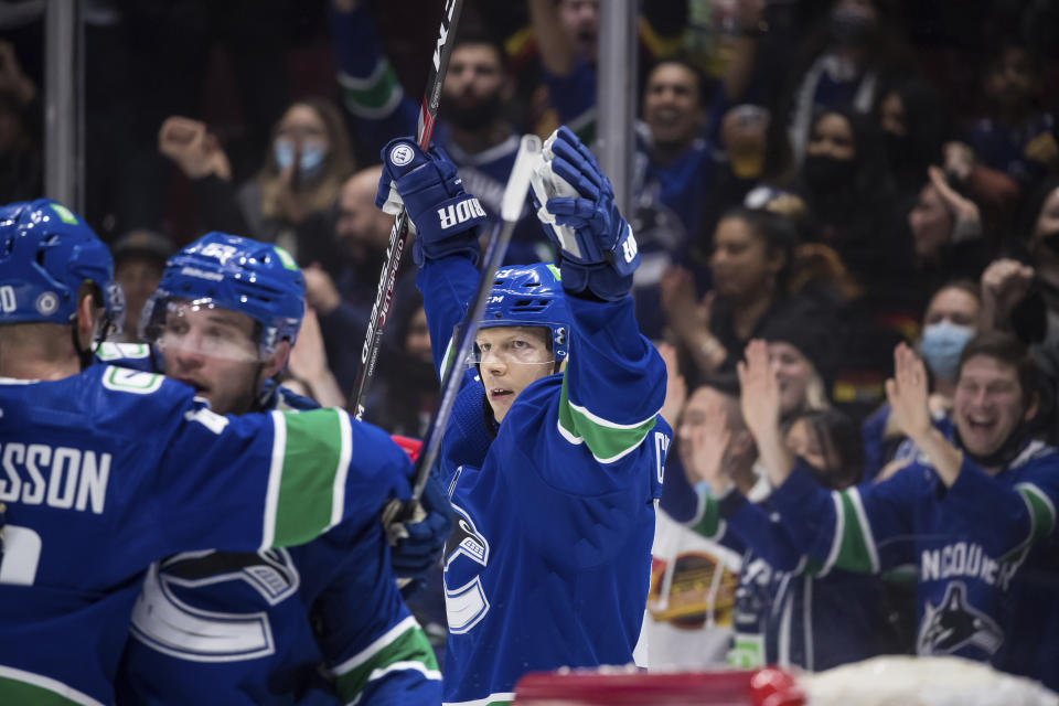 Vancouver Canucks' Alex Chiasson, back center, celebrates his goal against the Minnesota Wild during the second period of an NHL hockey game, Tuesday, Oct. 26, 2021 in Vancouver, British Columbia. (Darryl Dyck/The Canadian Press via AP)