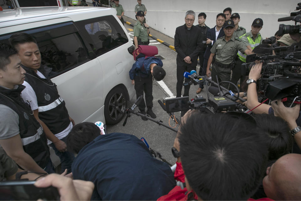 Chan Tong-kai, center, bows after talking to the media as he is released from prison in Hong Kong Wednesday, Oct. 23, 2019. A murder suspect whose case indirectly led to Hong Kong's ongoing protests was freed from prison on Wednesday and told reporters he was willing to surrender to authorities in Taiwan, where he is wanted for the killing of his girlfriend. (AP Photo/Mark Schiefelbein)