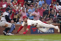 New York Yankees catcher Kyle Higashioka, left, prepares to tag St. Louis Cardinals' Nolan Gorman, right, out at home to end the third inning of a baseball game Saturday, Aug. 6, 2022, in St. Louis. (AP Photo/Jeff Roberson)