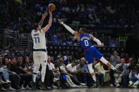 Dallas Mavericks guard Luka Doncic (77) shoots against LA Clippers guard Russell Westbrook (0) during the second half of Game 1 of an NBA basketball first-round playoff series in Los Angeles, Sunday, April 21, 2024. (AP Photo/Ashley Landis)